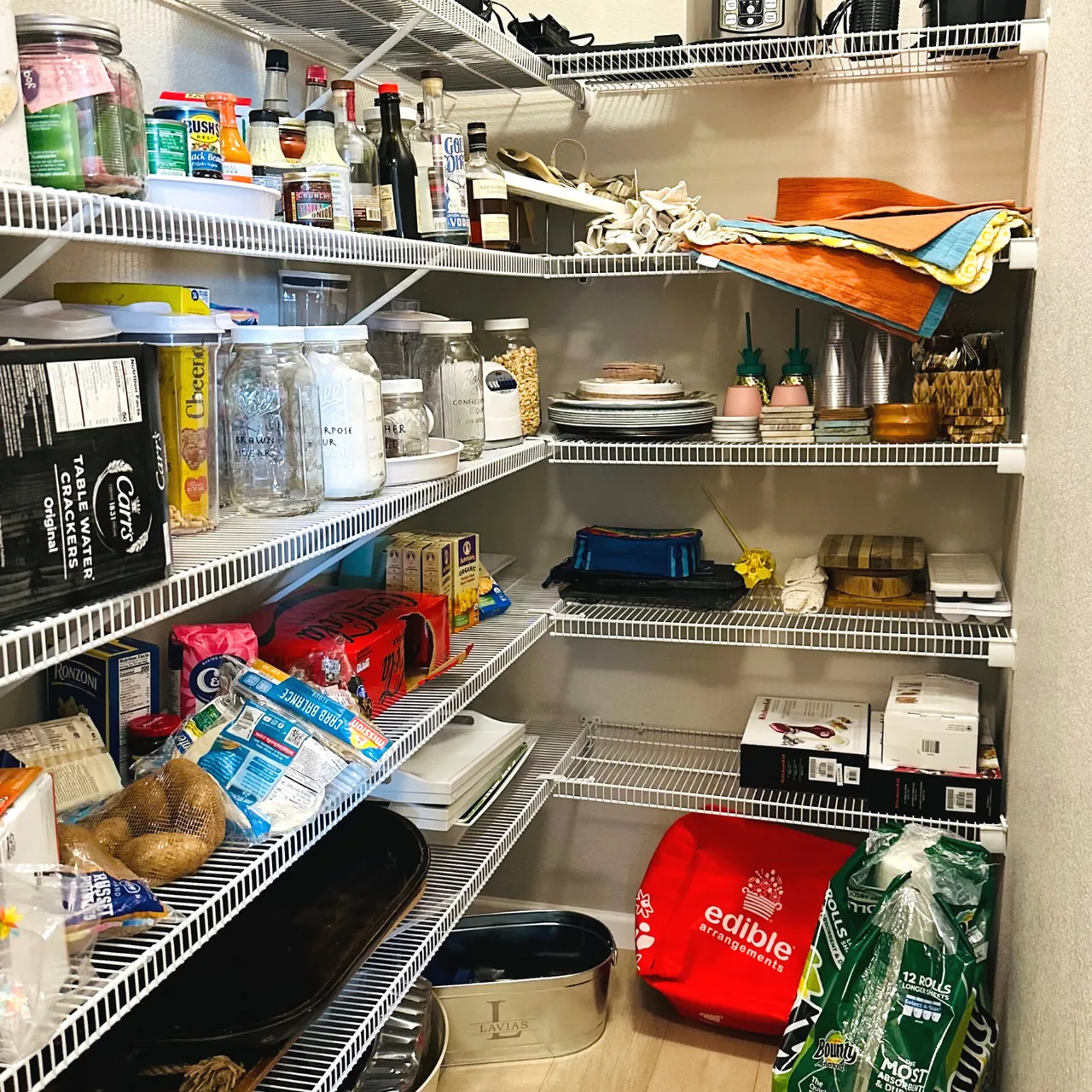 Crowded pantry with wire shelving before the Up Closets makeover