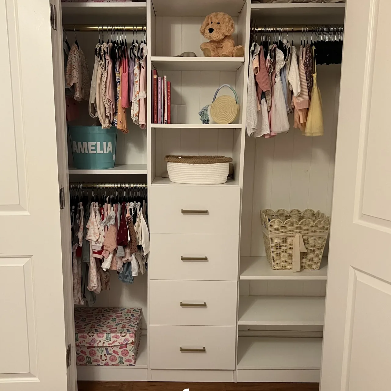 Kids' reach-in closet after installation with double hanging, drawers and cubbies